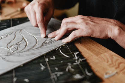 Handmade linocut art tools on a wooden surface — Haviva Seligson gift card