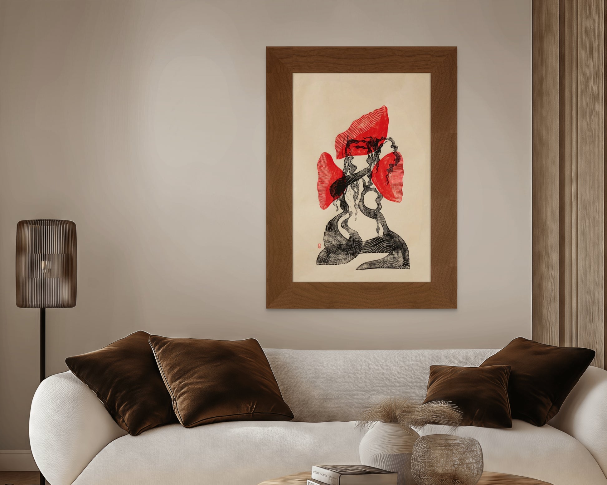 Living room with a white sofa, brown cushions, a lamp, and a framed red and black artwork on the wall.